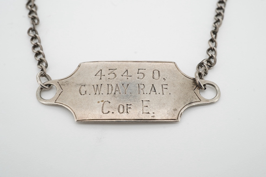 A silver military bracelet stamped sterling, and engraved ‘43450 G.W. Day, RAF C.ofE.’ X prisoner of war at Stalag prison. Condition - fair to good, one link requires rejoining.